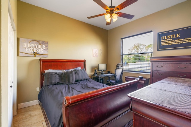 tiled bedroom featuring a closet and ceiling fan