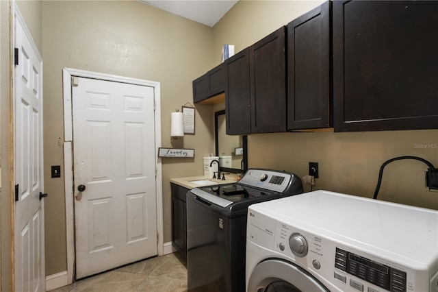 laundry room with light tile patterned flooring, cabinets, independent washer and dryer, and sink