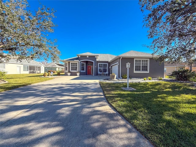 single story home featuring a garage and a front lawn