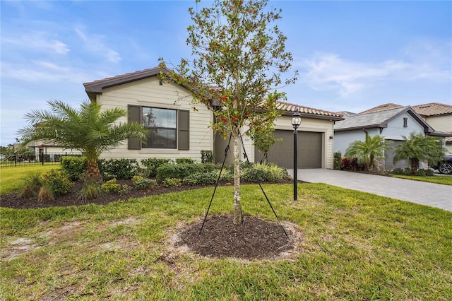 view of front of house featuring a front lawn and a garage