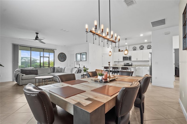 dining area with ceiling fan with notable chandelier and light tile patterned flooring