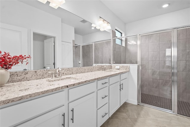 bathroom with vanity, tile patterned floors, and walk in shower