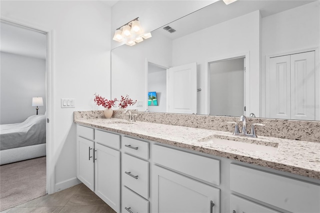 bathroom with tile patterned floors and vanity