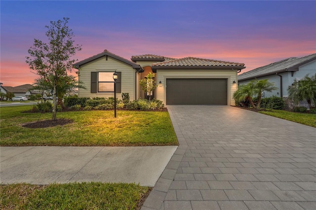 5107 Coral Reef Way, Bradenton, FL 34211 - view of front of home featuring a tiled roof, an attached garage, a yard, and decorative driveway
