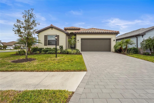5107 Coral Reef Way, Bradenton, FL 34211 - mediterranean / spanish-style home featuring decorative driveway, a garage, a tile roof, and a front lawn