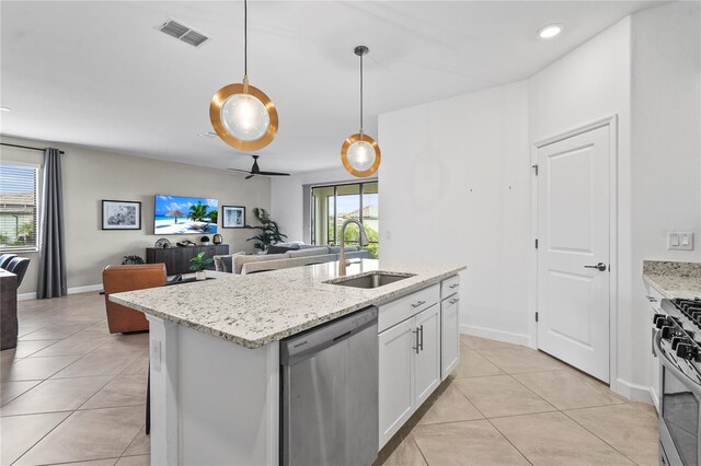 5107 Coral Reef Way, Bradenton, FL 34211 - kitchen with visible vents, open floor plan, white cabinets, a sink, and appliances with stainless steel finishes