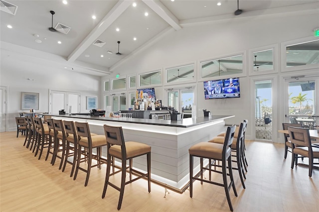 5107 Coral Reef Way, Bradenton, FL 34211 - kitchen with a large island, visible vents, light wood-type flooring, high vaulted ceiling, and beamed ceiling