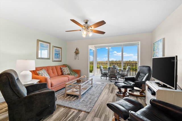 living room featuring ceiling fan and light wood-type flooring