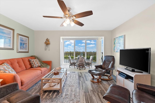 living room featuring hardwood / wood-style flooring and ceiling fan