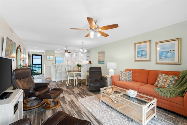 living room featuring hardwood / wood-style floors and ceiling fan