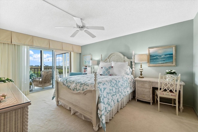 carpeted bedroom with a textured ceiling, access to outside, and ceiling fan