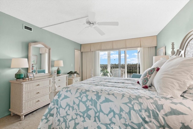 bedroom with light carpet, a textured ceiling, access to outside, and ceiling fan