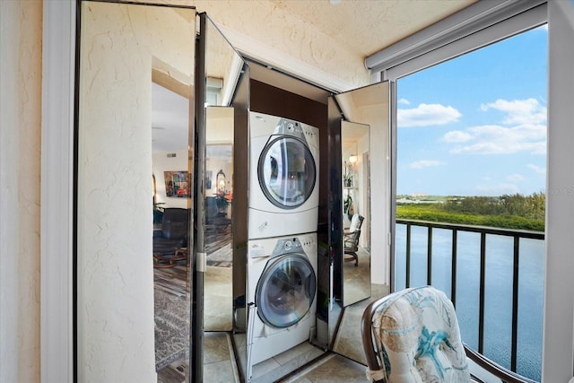 clothes washing area with stacked washer and dryer