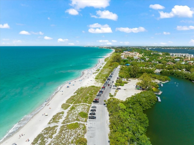 birds eye view of property featuring a water view and a beach view