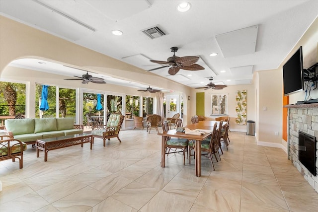 dining area with a fireplace and crown molding