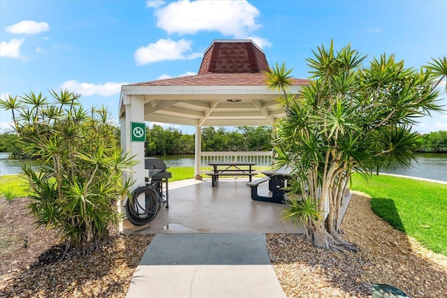 surrounding community with a gazebo and a water view