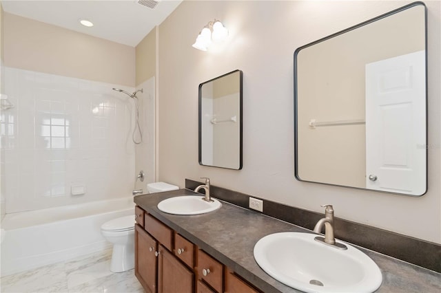 full bathroom with vanity, tiled shower / bath combo, and toilet