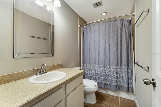 full bathroom featuring shower / tub combo with curtain, tile patterned floors, toilet, and vanity