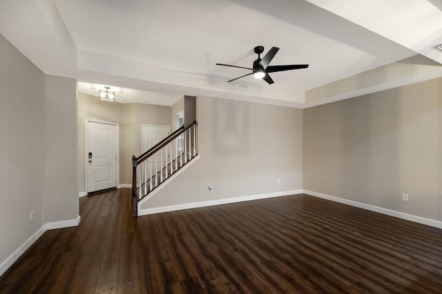 interior space with ceiling fan and dark hardwood / wood-style floors