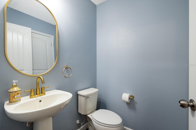 bathroom featuring sink and toilet