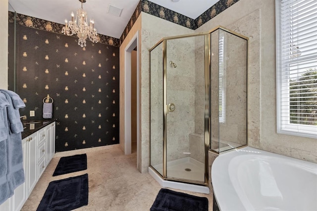 bathroom featuring vanity, plus walk in shower, and a chandelier