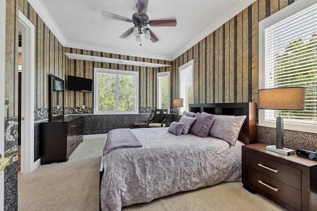 bedroom with ceiling fan, crown molding, and light carpet