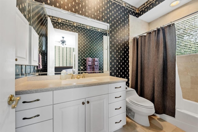 full bathroom with tile patterned floors, vanity, ceiling fan, shower / bathtub combination with curtain, and toilet