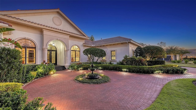 mediterranean / spanish-style house featuring french doors