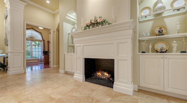 interior space with built in features and crown molding