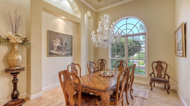 dining space with ornamental molding, a towering ceiling, and a chandelier