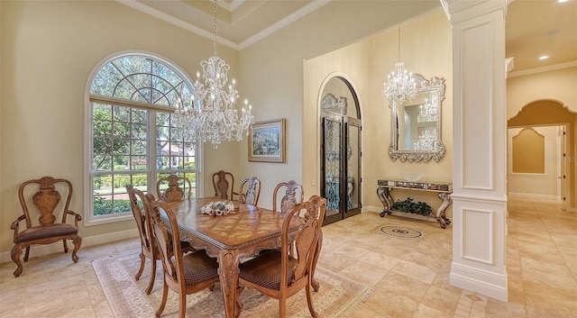 dining space with ornate columns, crown molding, a towering ceiling, and a wealth of natural light