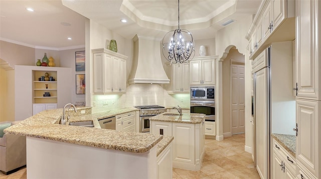 kitchen featuring sink, hanging light fixtures, kitchen peninsula, built in appliances, and custom exhaust hood