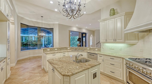 kitchen featuring pendant lighting, custom exhaust hood, an island with sink, appliances with stainless steel finishes, and kitchen peninsula