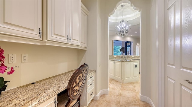 interior space with crown molding, light tile patterned flooring, and an inviting chandelier