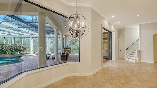 interior space with a notable chandelier, ornamental molding, and ornate columns