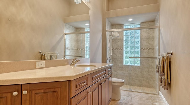 bathroom with tile patterned floors, vanity, toilet, and walk in shower