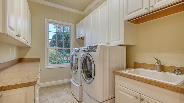 washroom with sink, cabinets, independent washer and dryer, light tile patterned floors, and ornamental molding