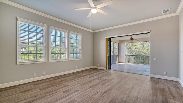 spare room with ceiling fan, light hardwood / wood-style floors, and ornamental molding