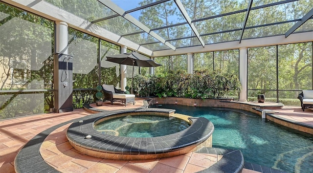 view of swimming pool featuring a lanai, a patio area, and an in ground hot tub