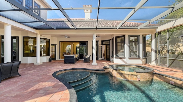 view of swimming pool with a lanai, ceiling fan, a patio, and an in ground hot tub