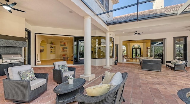 view of patio / terrace featuring a lanai, grilling area, an outdoor living space, and ceiling fan