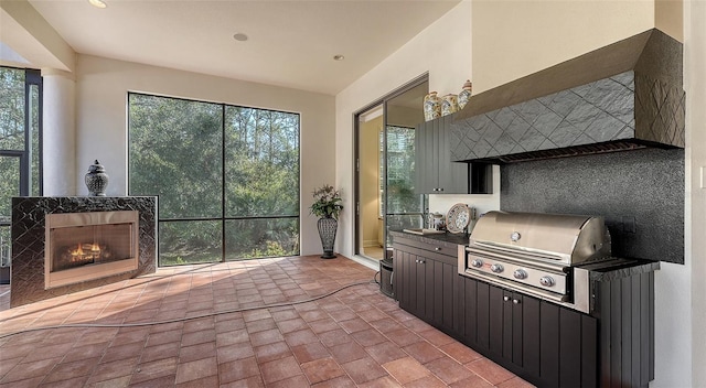 view of patio / terrace featuring area for grilling and a tiled fireplace