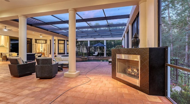 view of patio / terrace with an outdoor living space with a fireplace