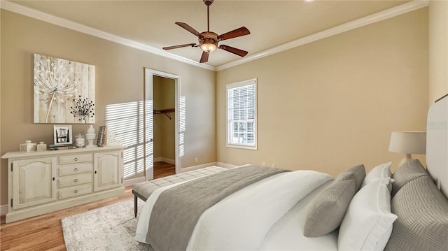 bedroom with ceiling fan, light wood-type flooring, and ornamental molding