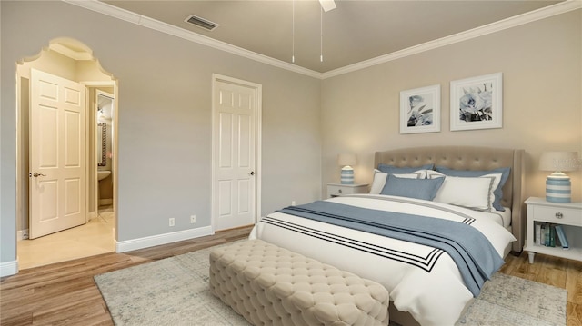 bedroom featuring ceiling fan, ornamental molding, and light wood-type flooring