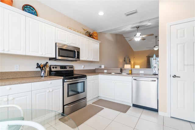 kitchen with white cabinetry, sink, vaulted ceiling, and appliances with stainless steel finishes