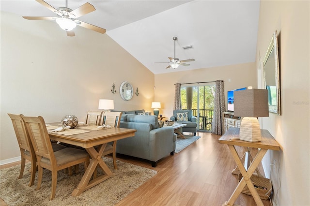 living room featuring hardwood / wood-style flooring, vaulted ceiling, and ceiling fan