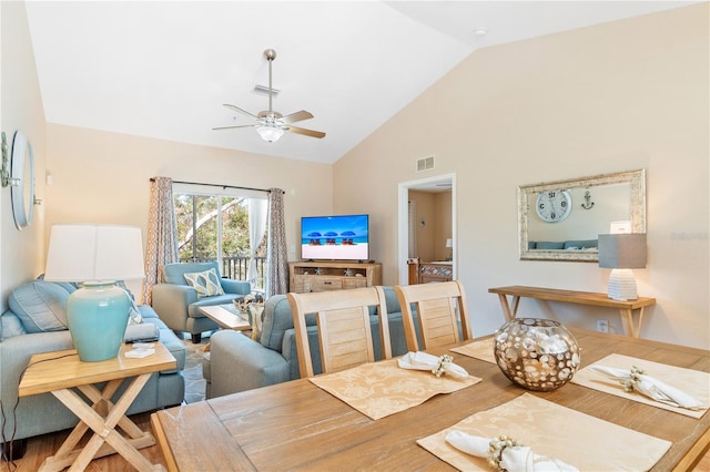 dining room with ceiling fan, lofted ceiling, and hardwood / wood-style flooring