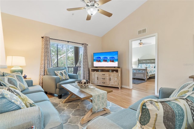 living room with light hardwood / wood-style flooring and lofted ceiling