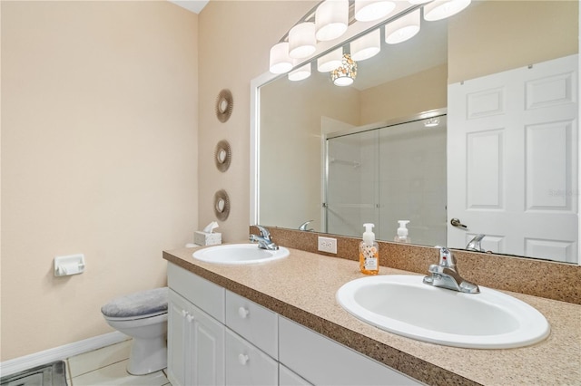 bathroom featuring tile patterned floors, vanity, toilet, and a shower with shower door